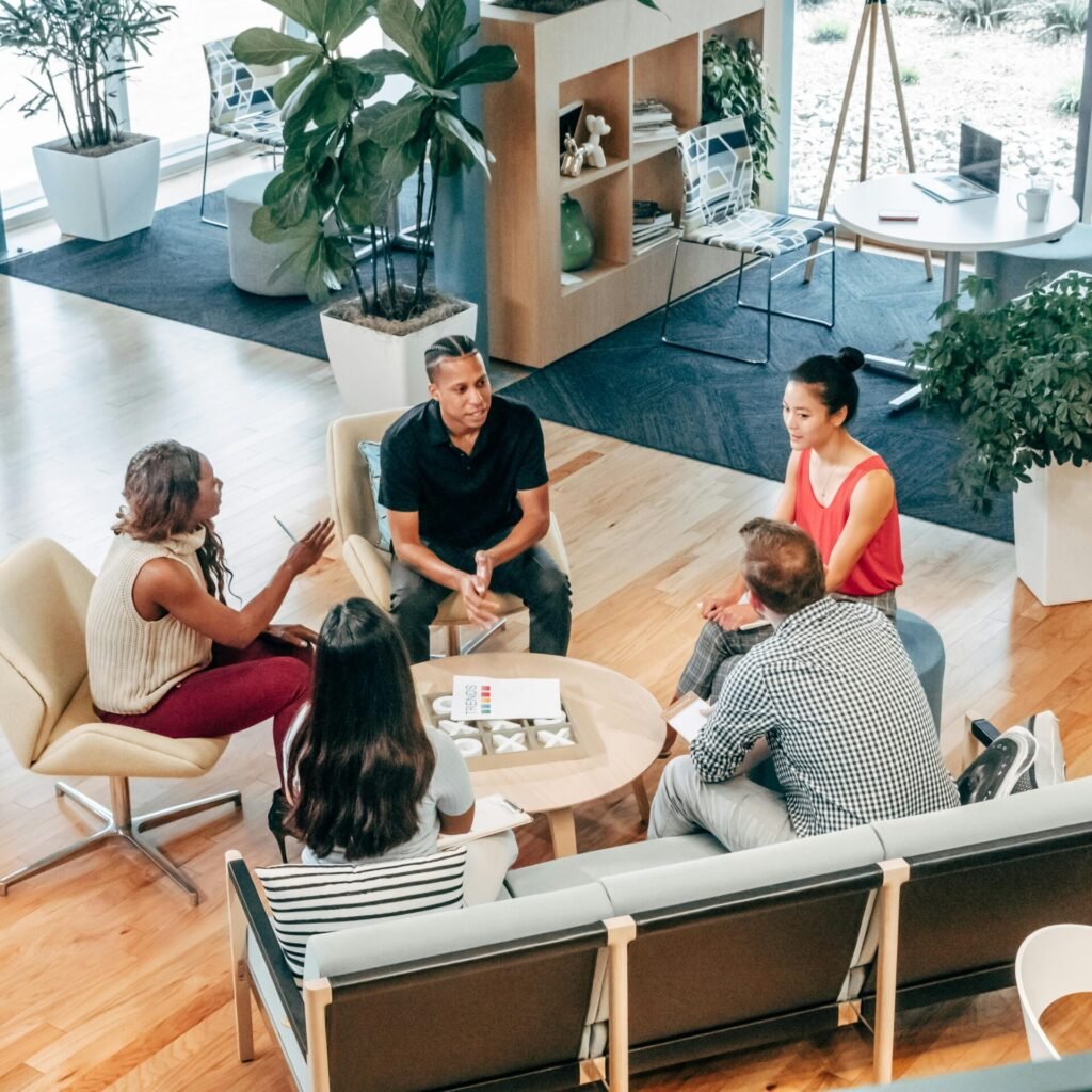 A diverse group of professionals engage in a collaborative team meeting in a stylish office environment.